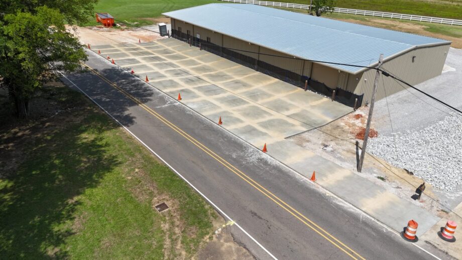Warehouse entrance with traffic cones and tree